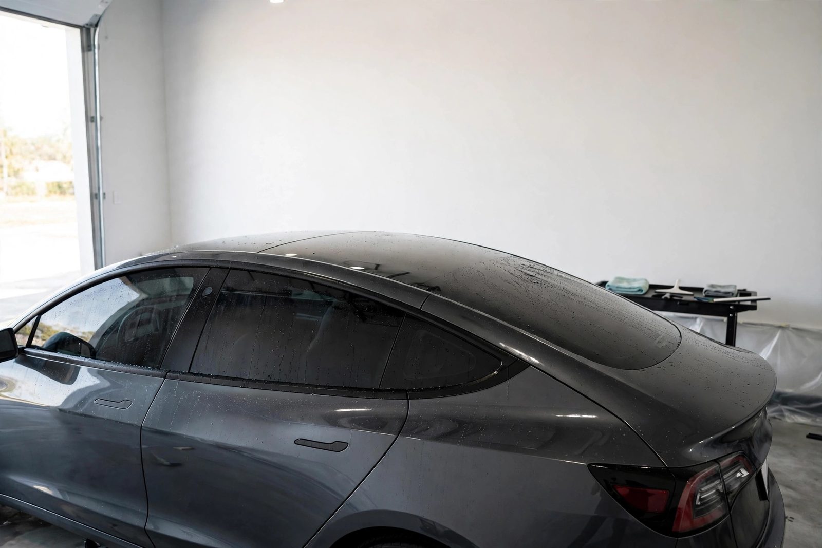 Car with freshly installed window tint curing in a Snellville install bay